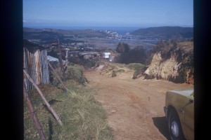 Driving into one of the squatter camps in the Child Welfare 'bakkie' (pickup), with the Knysna Lagoon and the 'white' town in the distance.